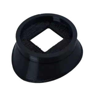 Close-up of a black circular plastic component with a square inner opening inside a cylindrical body