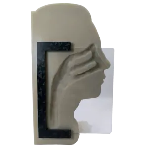 Side view of a beige anatomical head model with a dark geometric frame across the jaw area